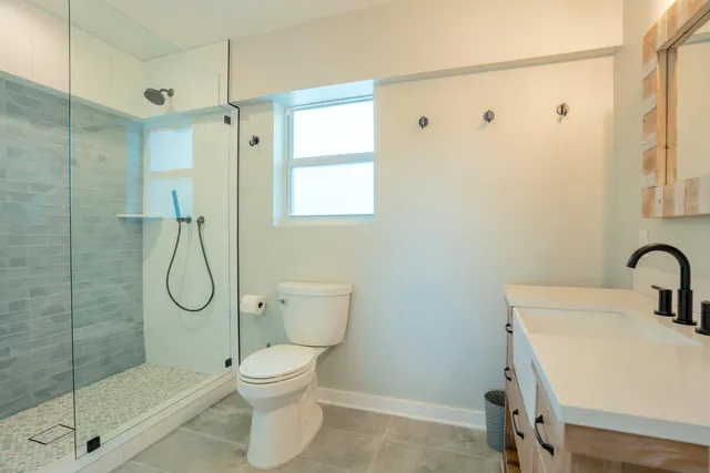 a large bed sitting in a bedroom next to a window