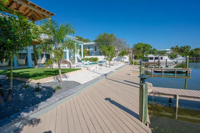 a view of a patio with dining table and chairs with wooden fence