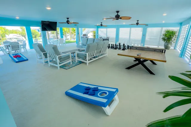 a living room with furniture pool table and a large window