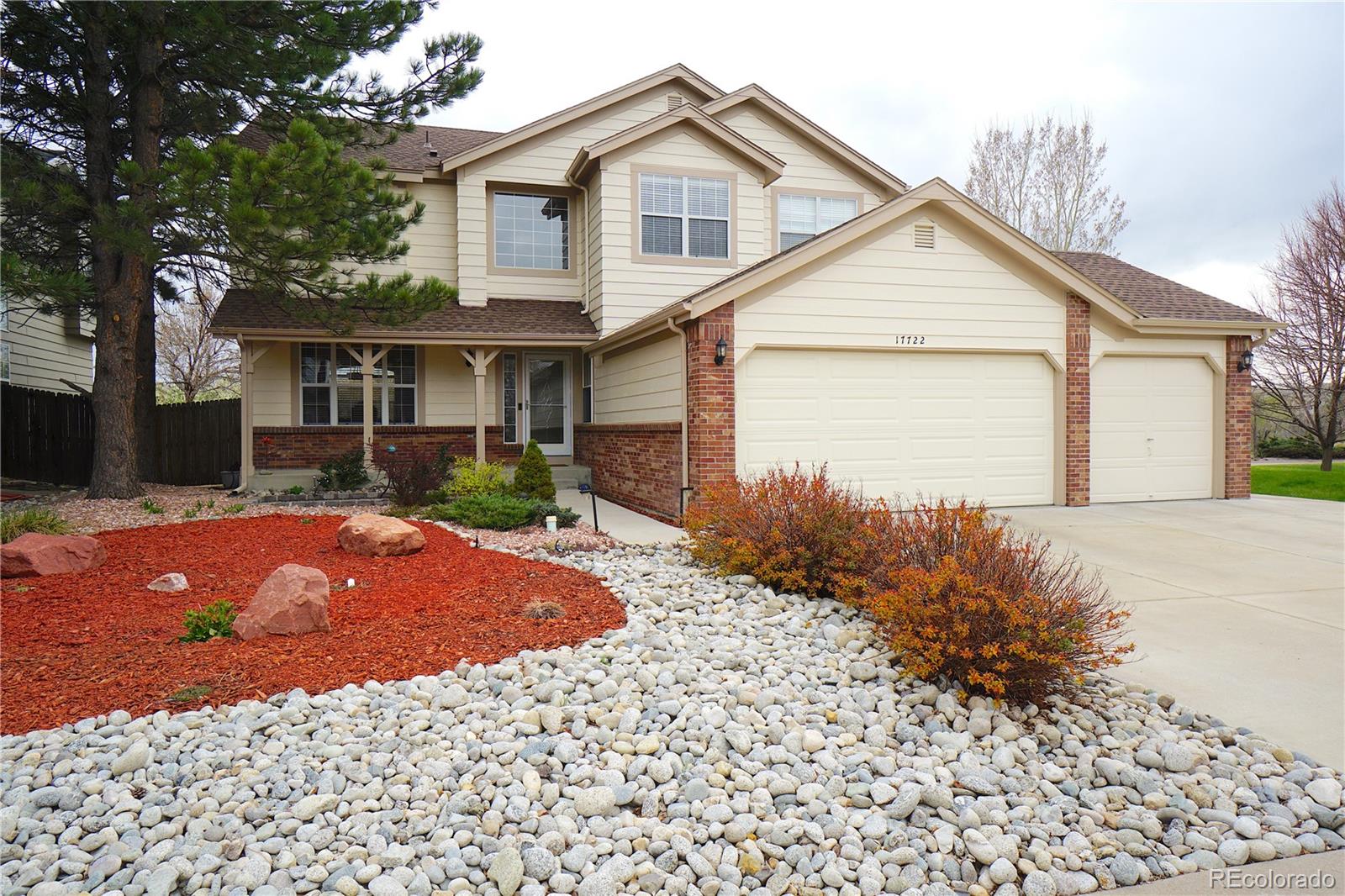 17722 East Ida Avenue Centennial, CO 80015 - Photo 1 of 45 a front view of a house with a yard and garage
