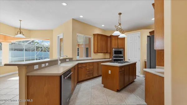 a kitchen with stainless steel appliances granite countertop a stove and a microwave