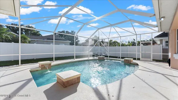 a view of a backyard with swimming pool