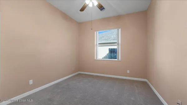 an empty room with windows and outdoor view
