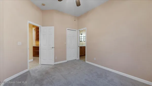 an empty room with windows and closet