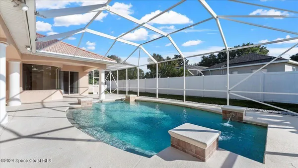 a view of a backyard with couches chair and fire pit