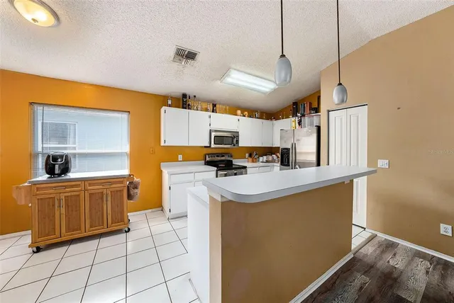 a kitchen with cabinets and window