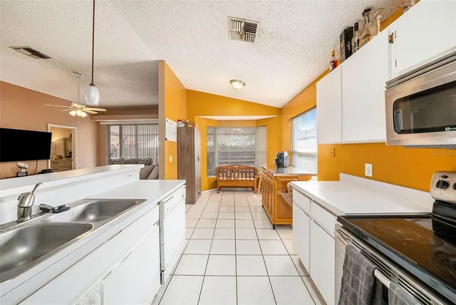 a kitchen with a sink stove and microwave