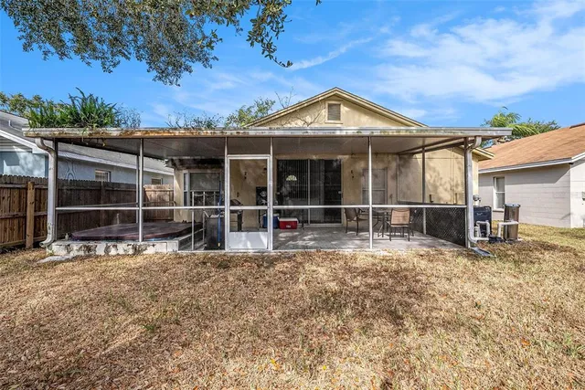a view of a house with a large window and wooden fence