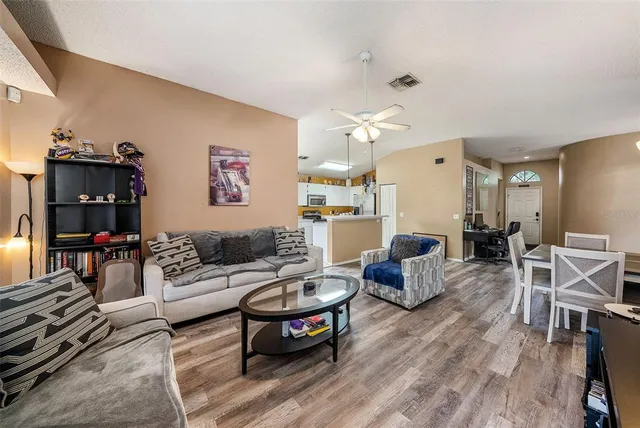 a living room with furniture and wooden floor
