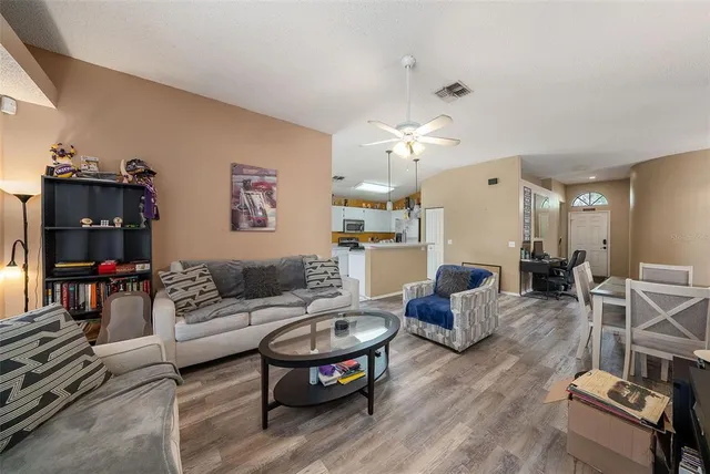 a living room with furniture and a chandelier