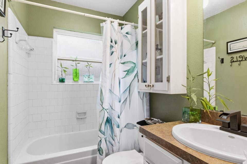 9211 Benwick Street Spring, TX 77379 - Photo 21 of 27 a bathroom with a sink a toilet and shower