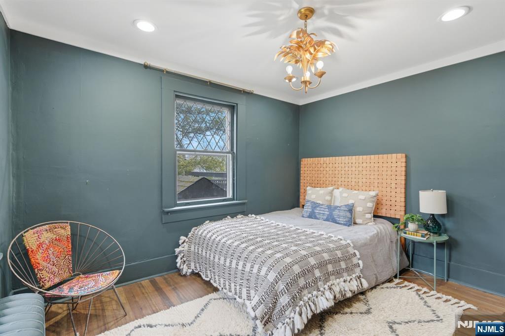 44 Norman Road Montclair, NJ 07043 - Photo 20 of 40 a bedroom with a bed and a chandelier
