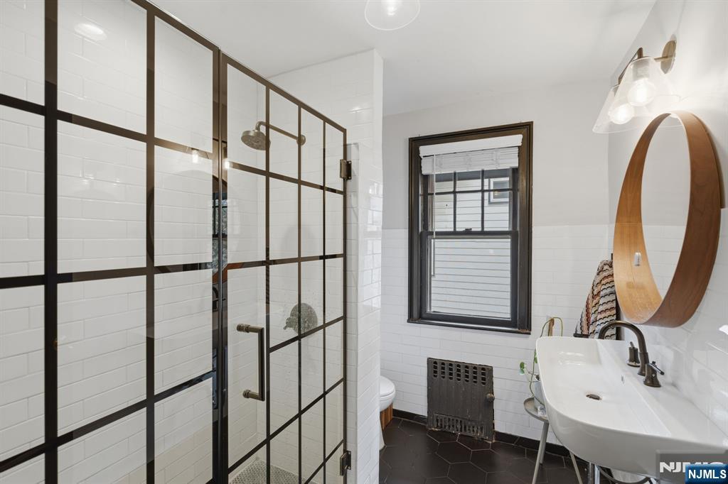 44 Norman Road Montclair, NJ 07043 - Photo 21 of 40 a bathroom with a sink and a mirror
