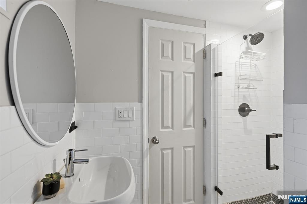 44 Norman Road Montclair, NJ 07043 - Photo 29 of 40 a bathroom with a sink a toilet and shower