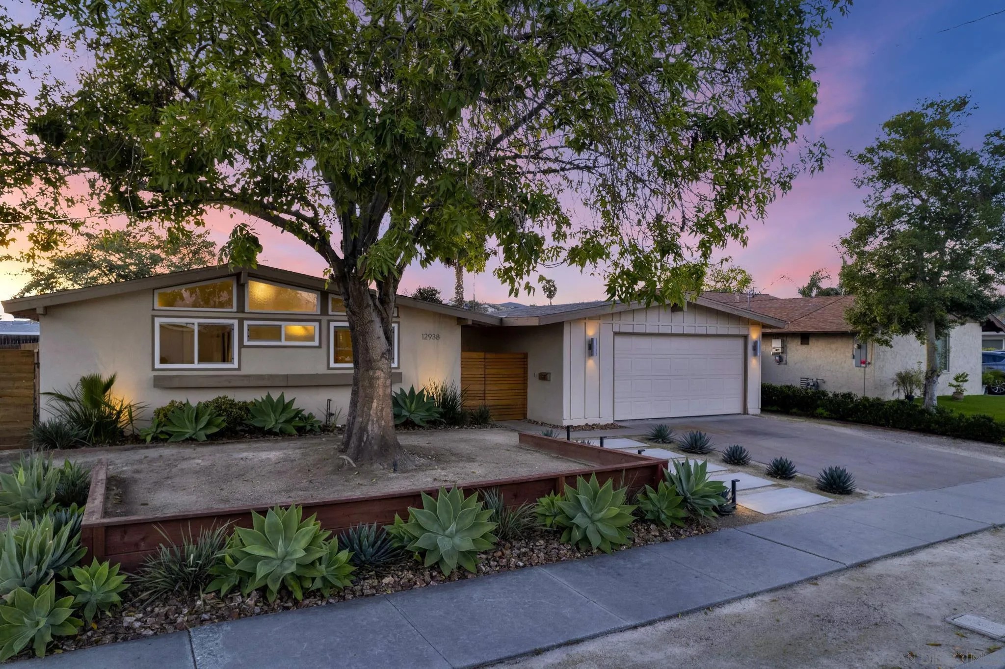 a front view of a house with a garden