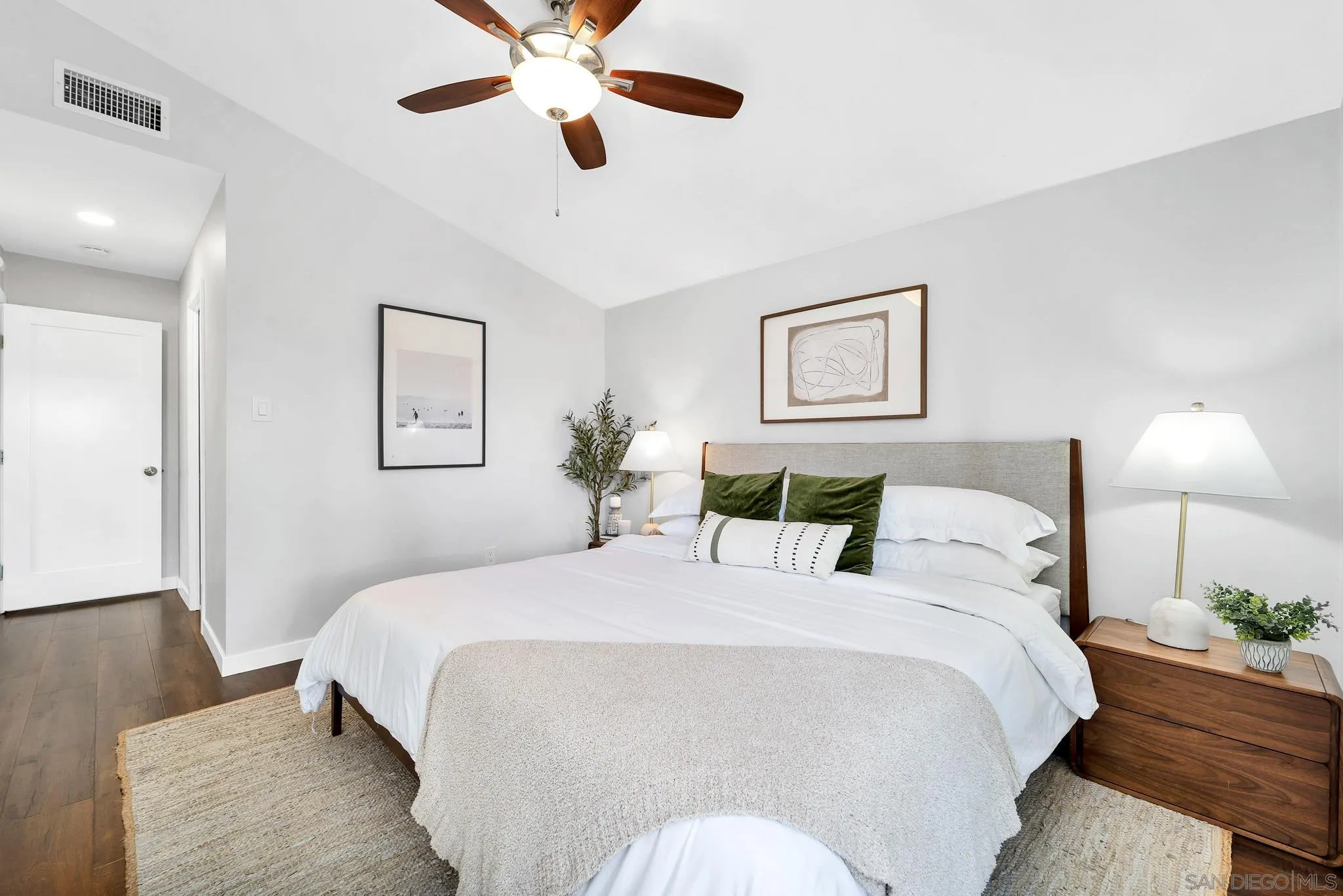 12938 Conley Street Poway, CA 92064 - Photo 12 of 30 a bedroom with a large bed and a chandelier