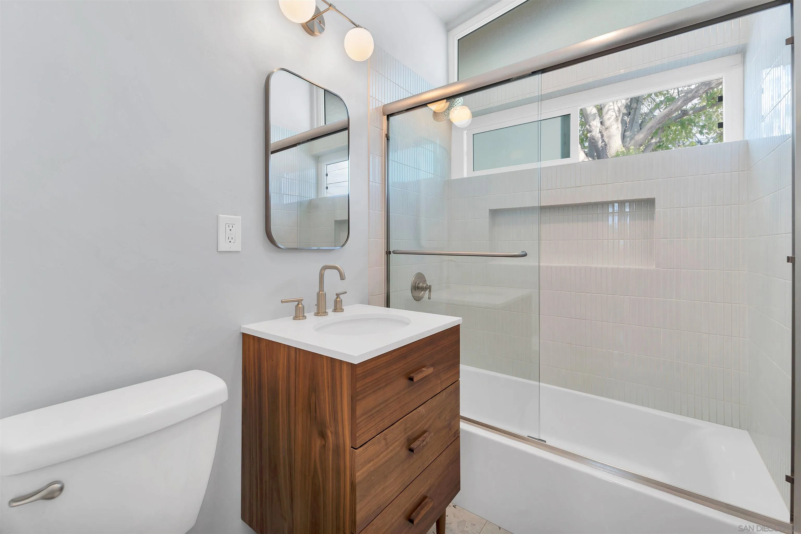12938 Conley Street Poway, CA 92064 - Photo 19 of 30 a bathroom with a sink a toilet and a mirror