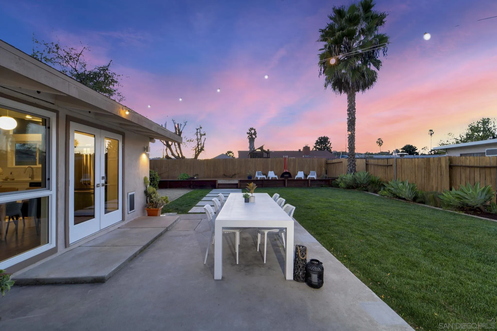 12938 Conley Street Poway, CA 92064 - Photo 20 of 30 a table and chairs sitting in front of a house
