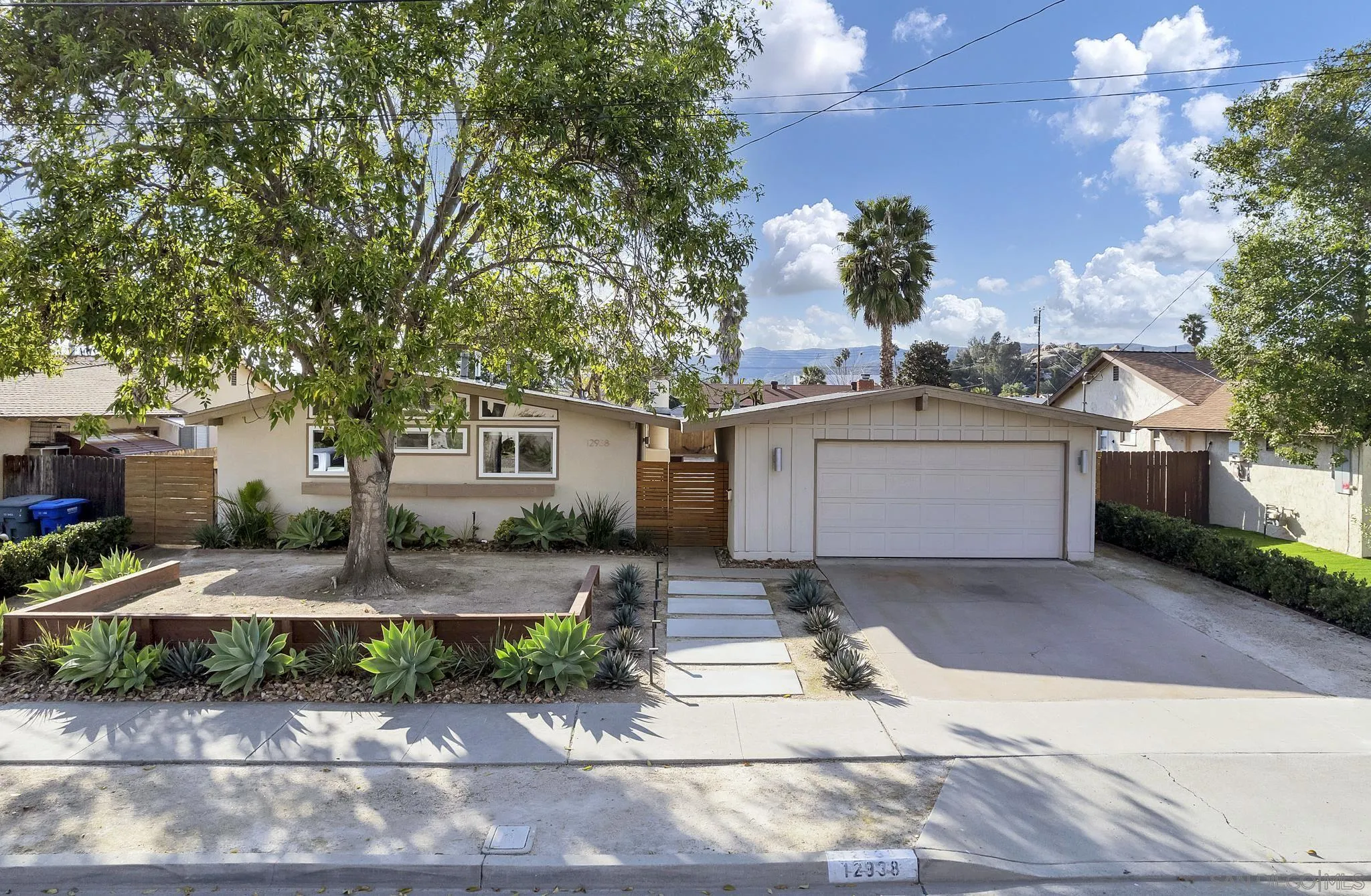 12938 Conley Street Poway, CA 92064 - Photo 2 of 30 a front view of a house with garden