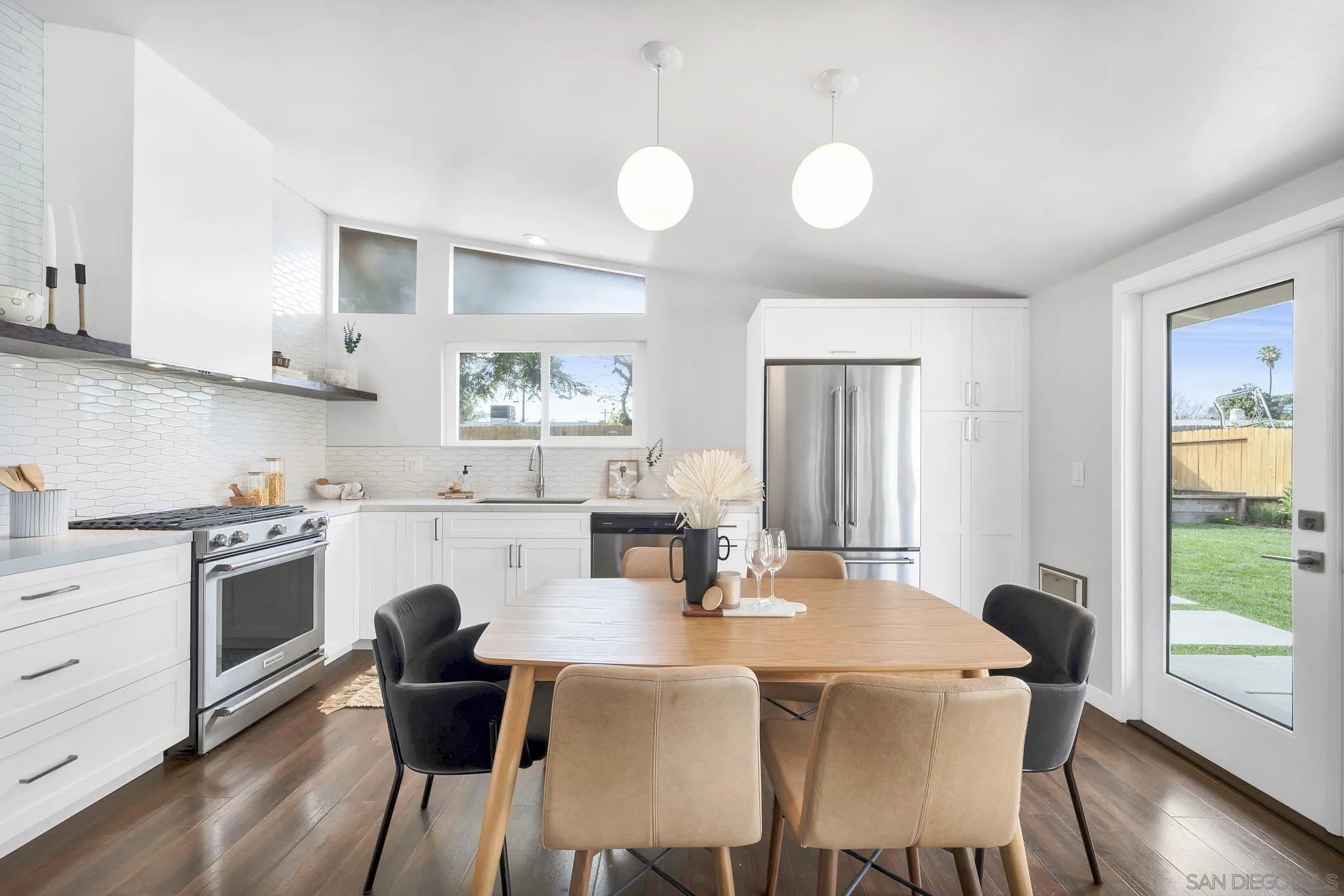 12938 Conley Street Poway, CA 92064 - Photo 8 of 30 a kitchen with a table chairs stove and white cabinets