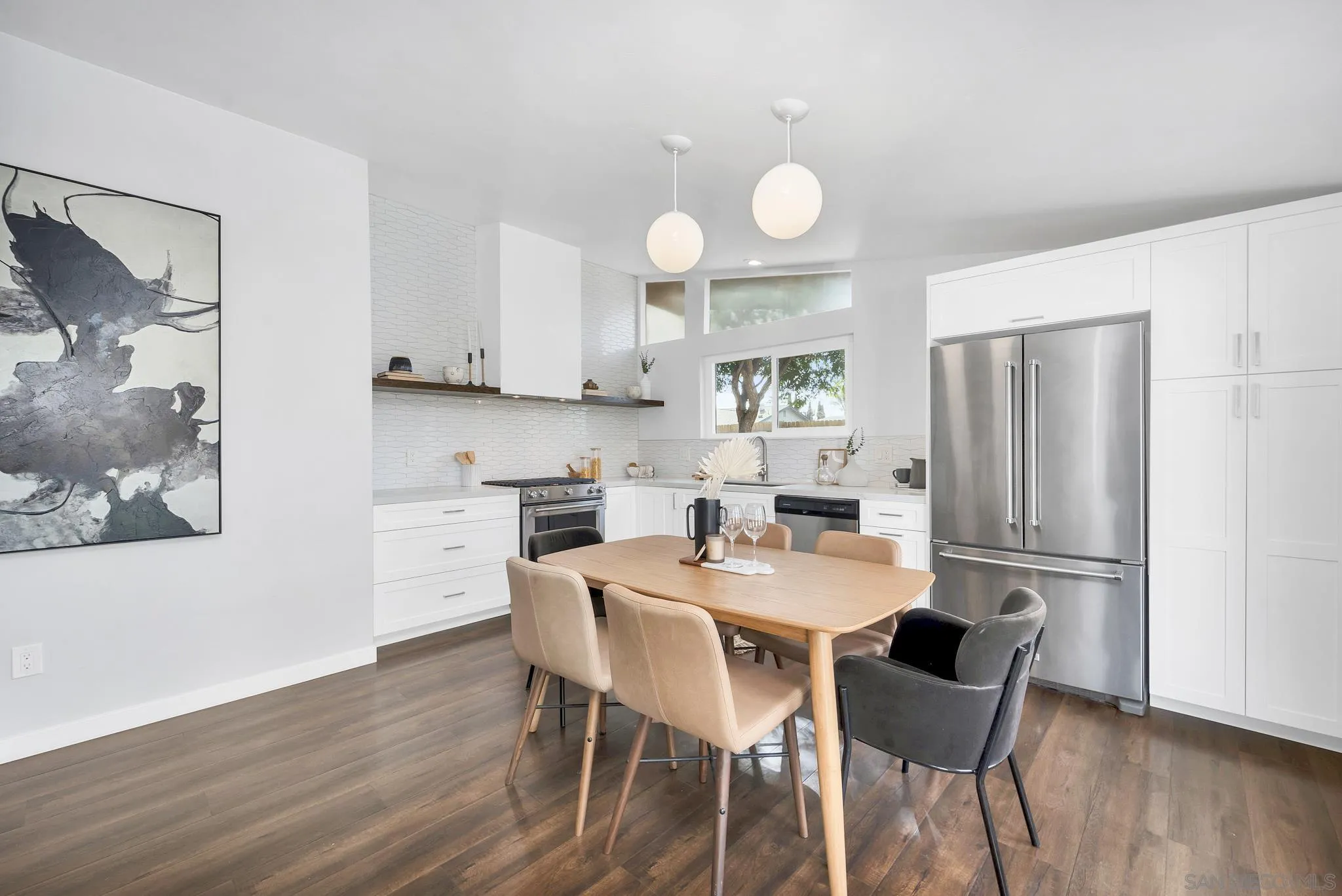 12938 Conley Street Poway, CA 92064 - Photo 9 of 30 a kitchen with stainless steel appliances a dining table chairs and wooden floor