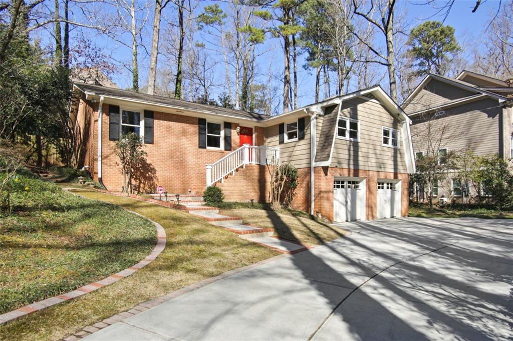 a view of a white house with a yard