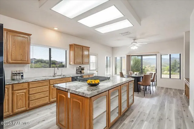 a living room with stainless steel appliances kitchen island granite countertop furniture and a kitchen view