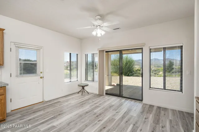 a bedroom with a bed flat screen tv and a large window