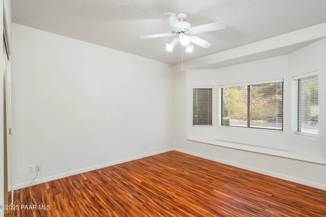 a front view of house with yard and trees in the background