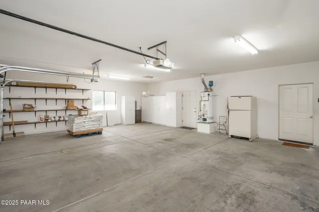 a view of a house with potted plants and a large tree