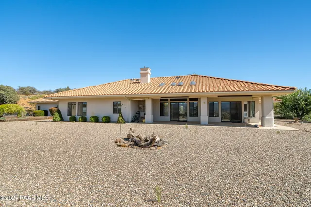 a bathroom with a granite countertop sink a toilet and a mirror