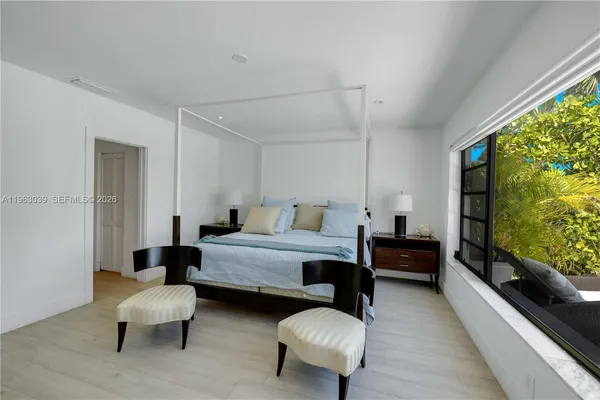 a bedroom with furniture and a flat screen tv