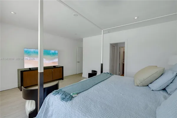 a bedroom with a bed and a chair