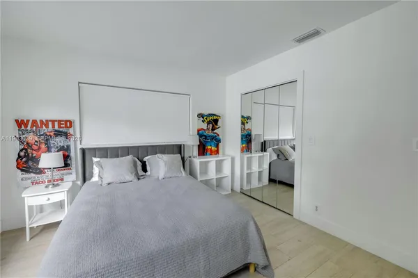 a bed room with a bed and a chair