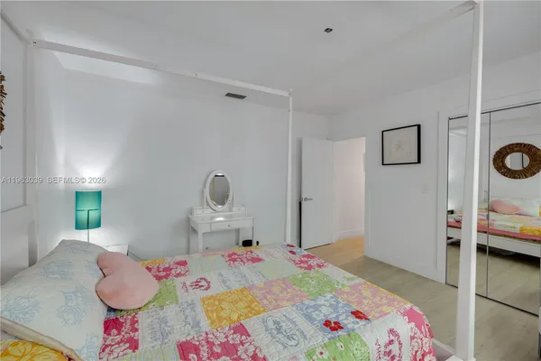 a bedroom with a bed and a dresser