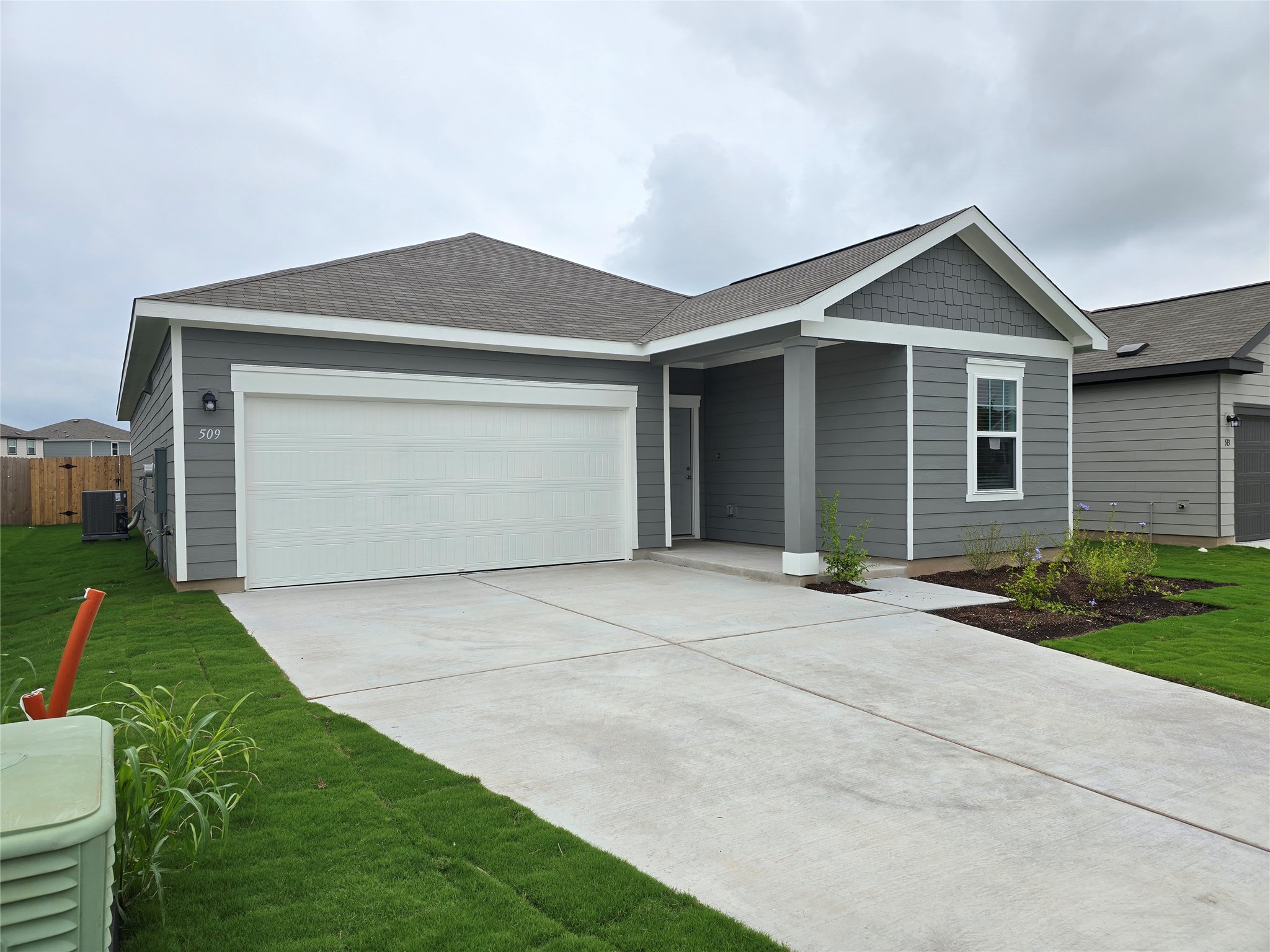 509 McFadin Way Taylor, TX 76574 - Photo 2 of 23 a front view of a house with yard