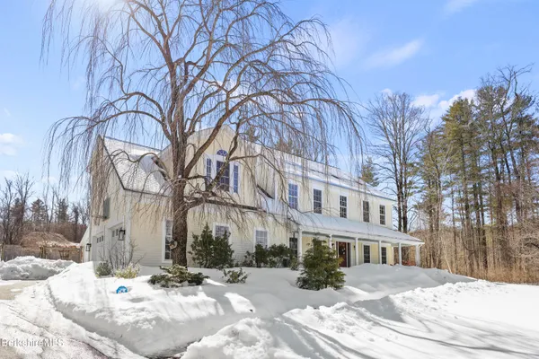 a view of a building with a snow in the yard