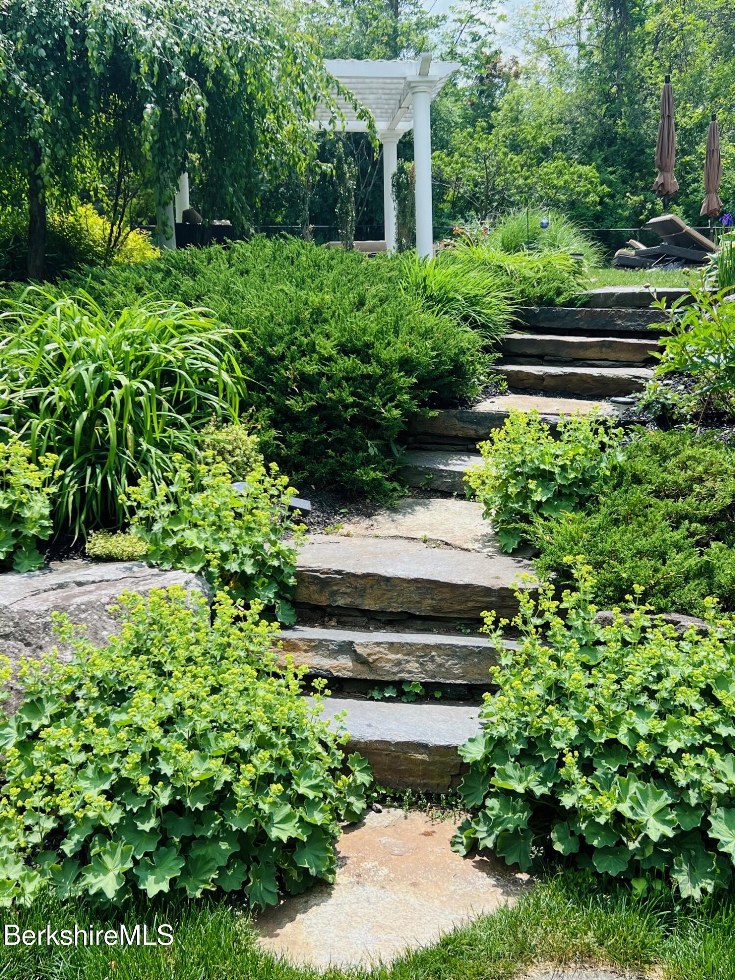 130 East Dugway Road Lenox, MA 01240 - Photo 76 of 89 a view of a garden with a bench