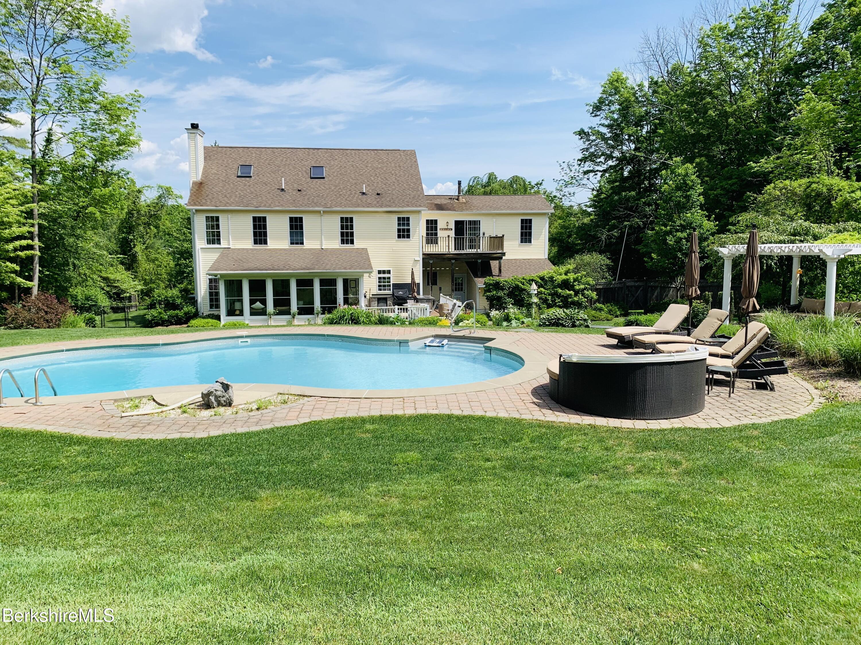 130 East Dugway Road Lenox, MA 01240 - Photo 84 of 89 a view of a swimming pool with lawn chairs and plants