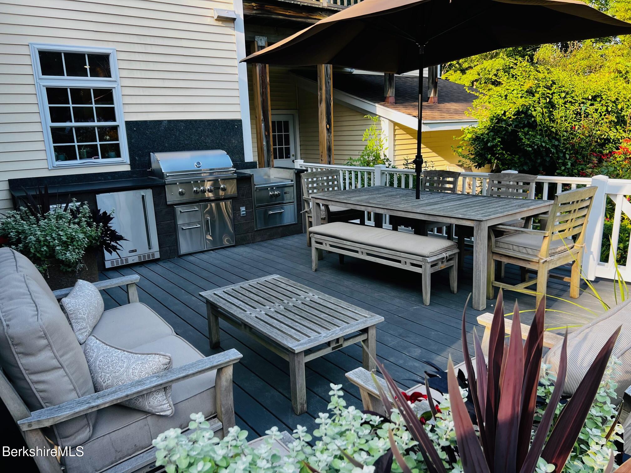 130 East Dugway Road Lenox, MA 01240 - Photo 87 of 89 a view of a patio with table and chairs with wooden floor and fence