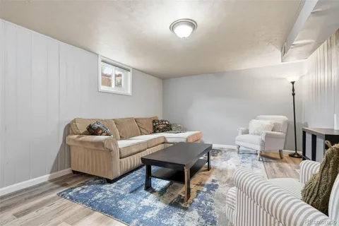a living room with furniture a rug and a table