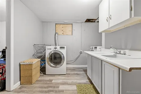 a utility room with sink dryer and washer
