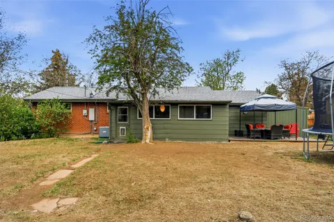 a view of a house with a yard and tree