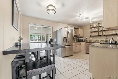 a kitchen with refrigerator cabinets dining table and chairs