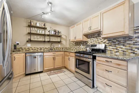 a kitchen with cabinets appliances and a counter space