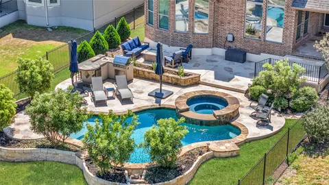 an aerial view of a house with swimming pool garden and patio