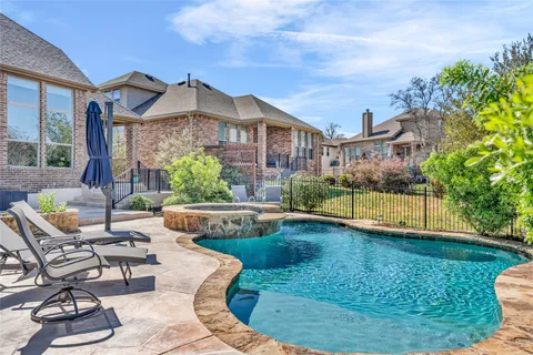 a view of a house with backyard porch and sitting area