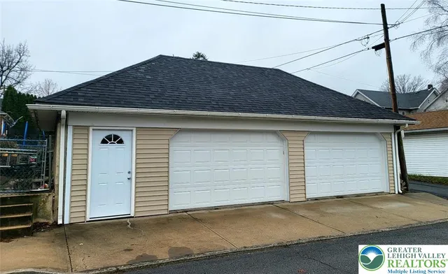 a small white house with outdoor space