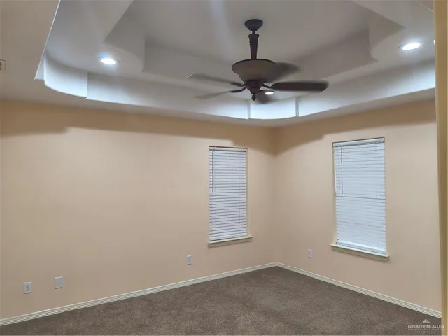 a view of room with a ceiling fan and window