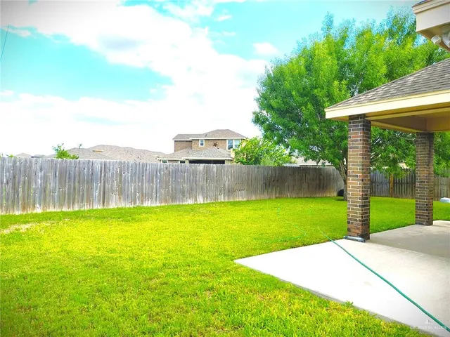 a view of a backyard with a garden and deck